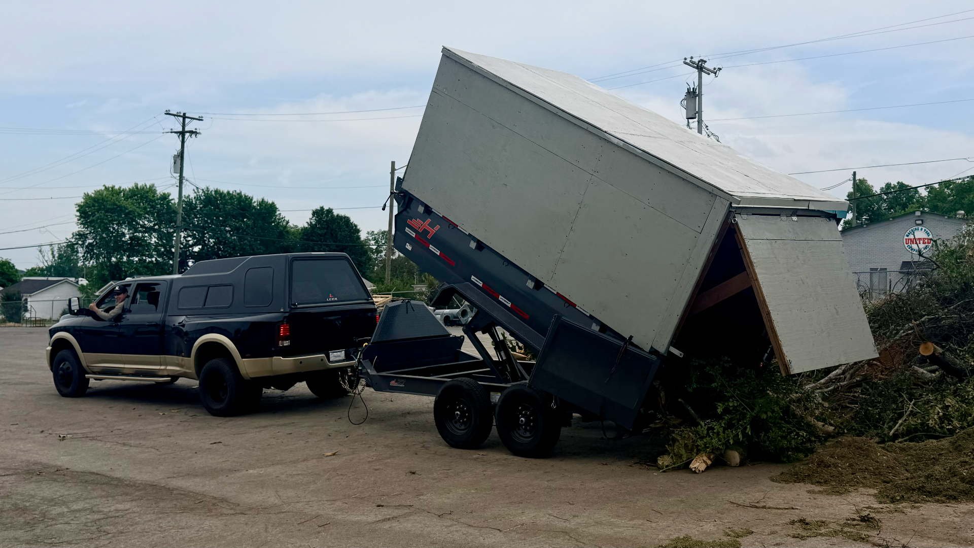 Hauling Patriots dump trailer unloading debris on a Nashville-area job